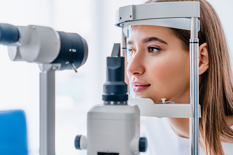 Woman checking her vision at the optometrist.